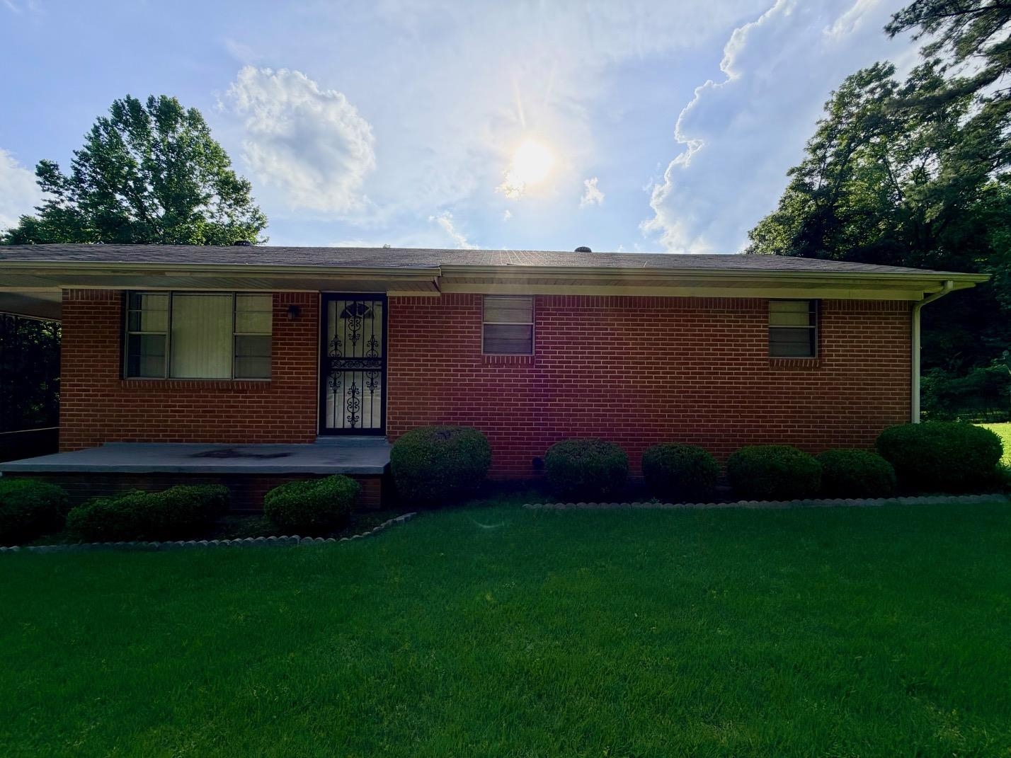 321 Pipkin Road Jackson, TN 38305 - Photo 1 of 16 a front view of a house with a garden
