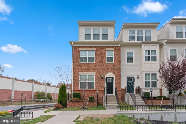 a front view of a residential apartment building with a yard