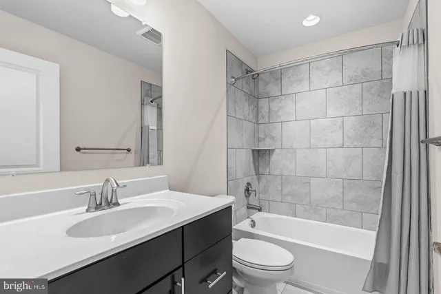 a bathroom with a sink a toilet and a bathtub