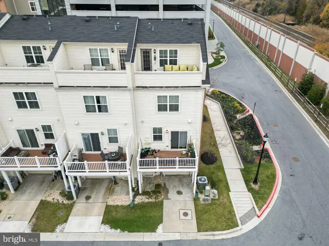 a large white kitchen with a white countertops and wooden floor