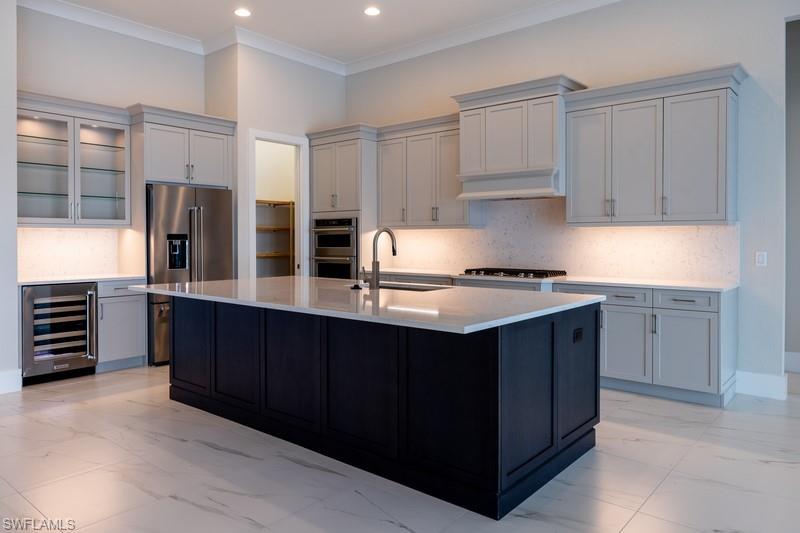 8892 Nevis Way Naples, FL 34113 - Photo 2 of 5 a kitchen with granite countertop a stove and a refrigerator