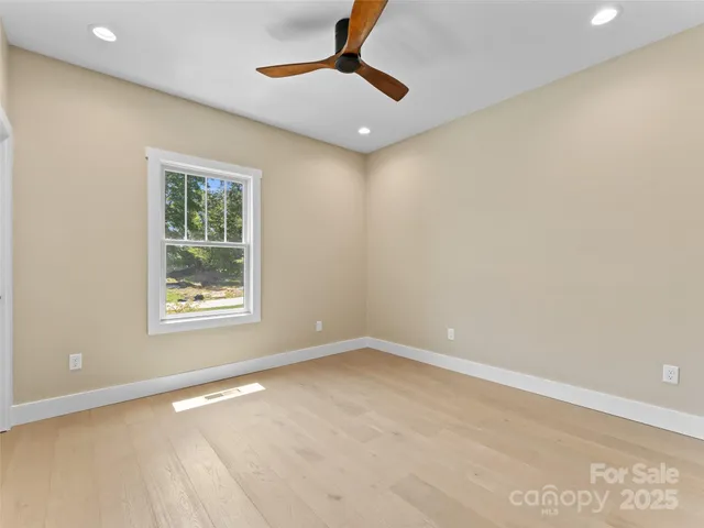 an empty room with closet and windows