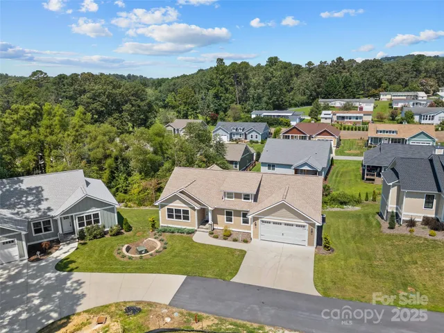 an aerial view of residential houses with outdoor space and street view