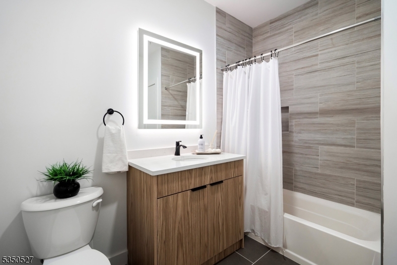 310 West Jersey Street, Unit 404 Elizabeth, NJ 07202 - Photo 4 of 14 a bathroom with a sink toilet and shower