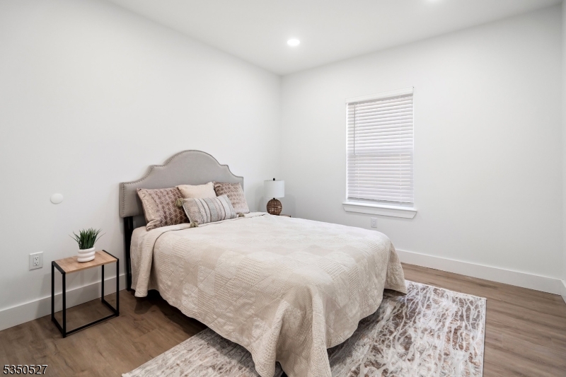 310 West Jersey Street, Unit 404 Elizabeth, NJ 07202 - Photo 7 of 14 a bedroom with a bed and a window