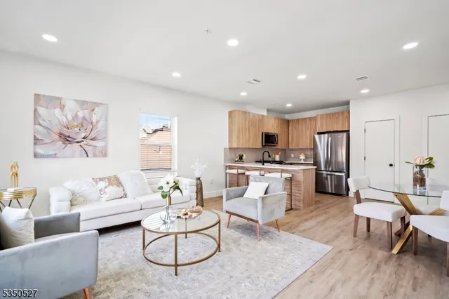 a living room with furniture and kitchen view
