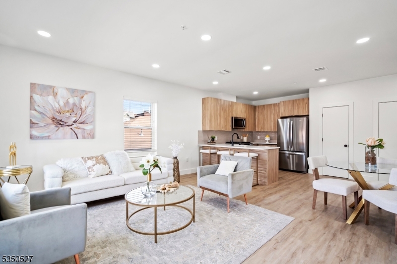 310 West Jersey Street, Unit 404 Elizabeth, NJ 07202 - Photo 9 of 14 a living room with furniture and kitchen view