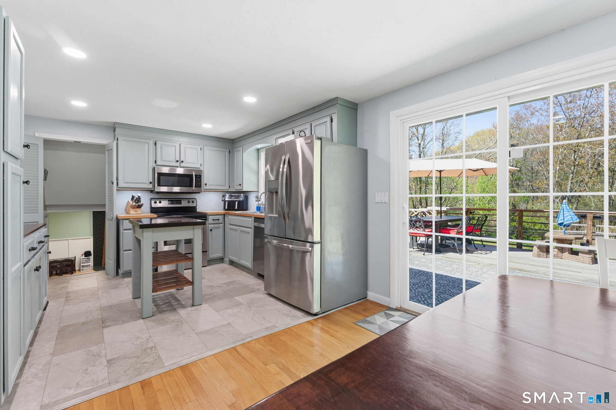 523 Essex Road Westbrook, CT 06498 - Photo 12 of 37 a kitchen with stainless steel appliances granite countertop a refrigerator a stove a sink a microwave and island
