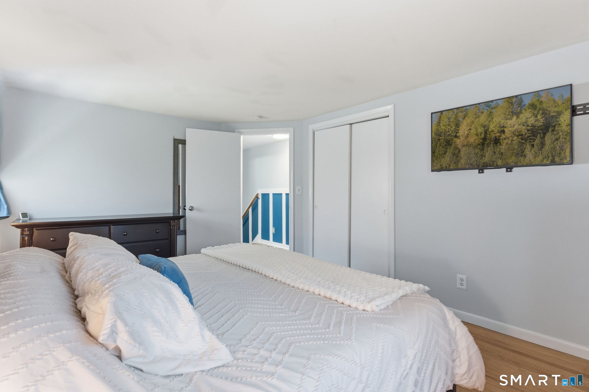 523 Essex Road Westbrook, CT 06498 - Photo 14 of 37 a bedroom with a bed and a flat screen tv