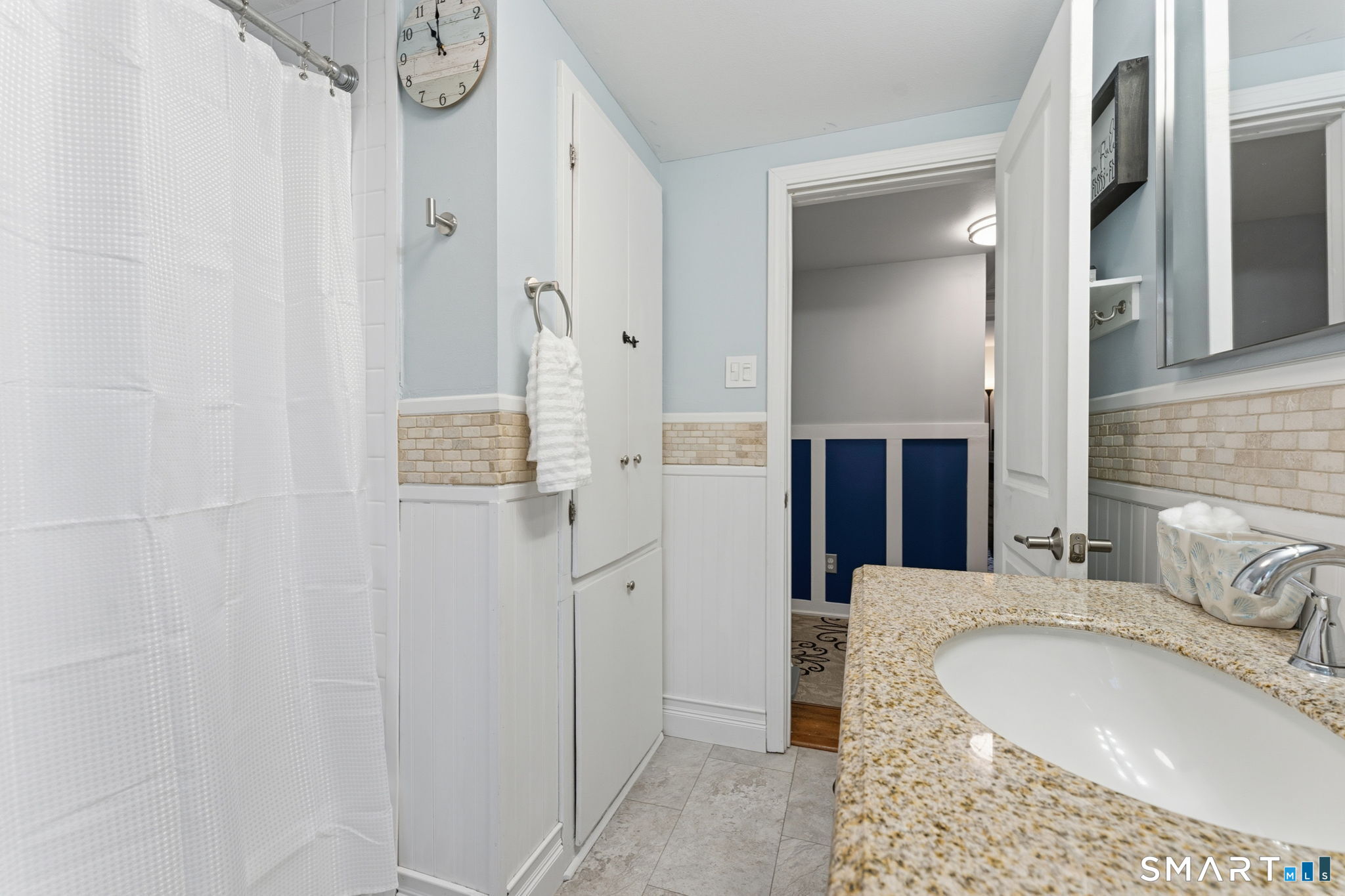 523 Essex Road Westbrook, CT 06498 - Photo 22 of 37 a bathroom with a granite countertop sink and a mirror