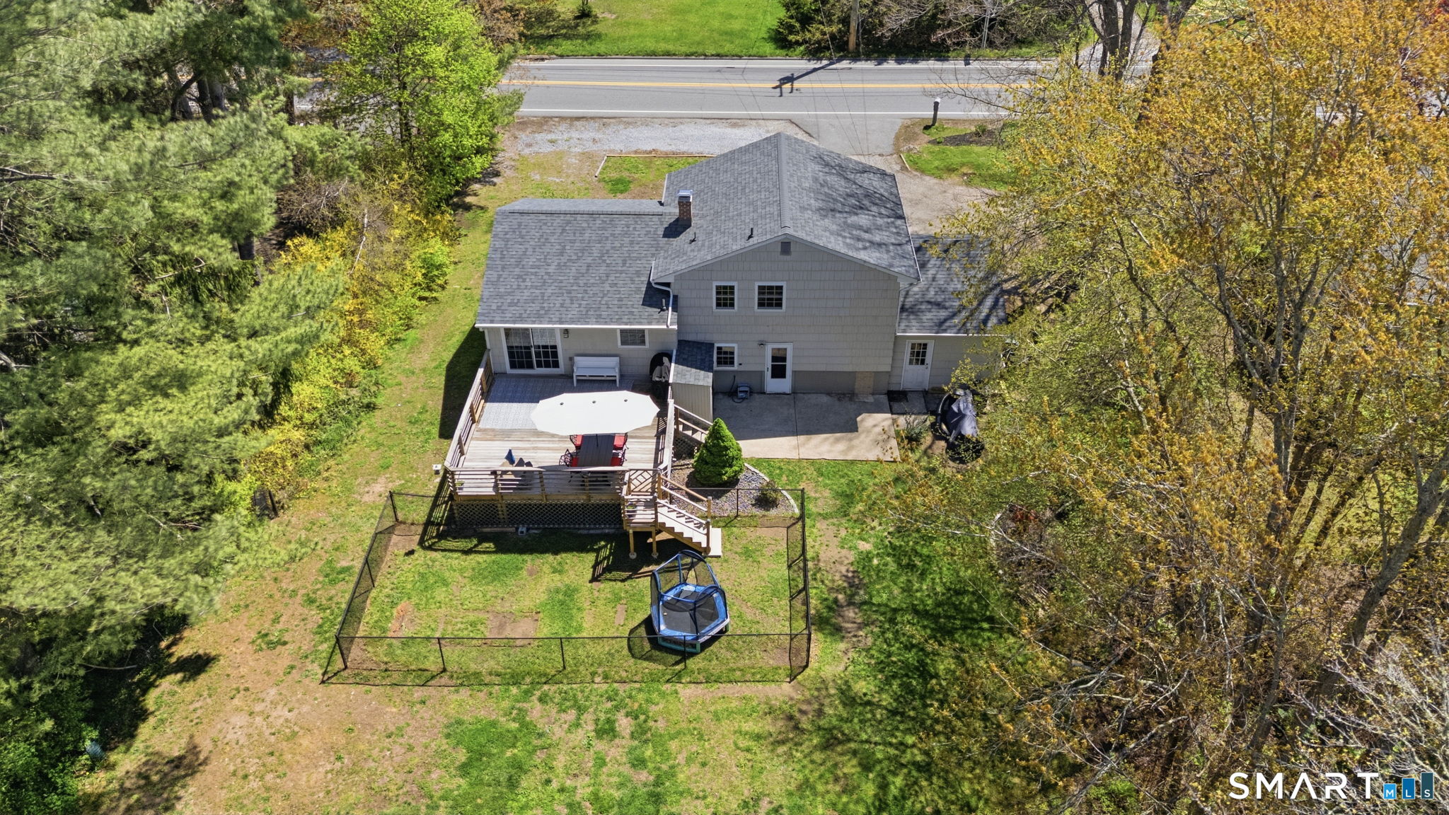 523 Essex Road Westbrook, CT 06498 - Photo 33 of 37 an aerial view of a house with swimming pool and large trees