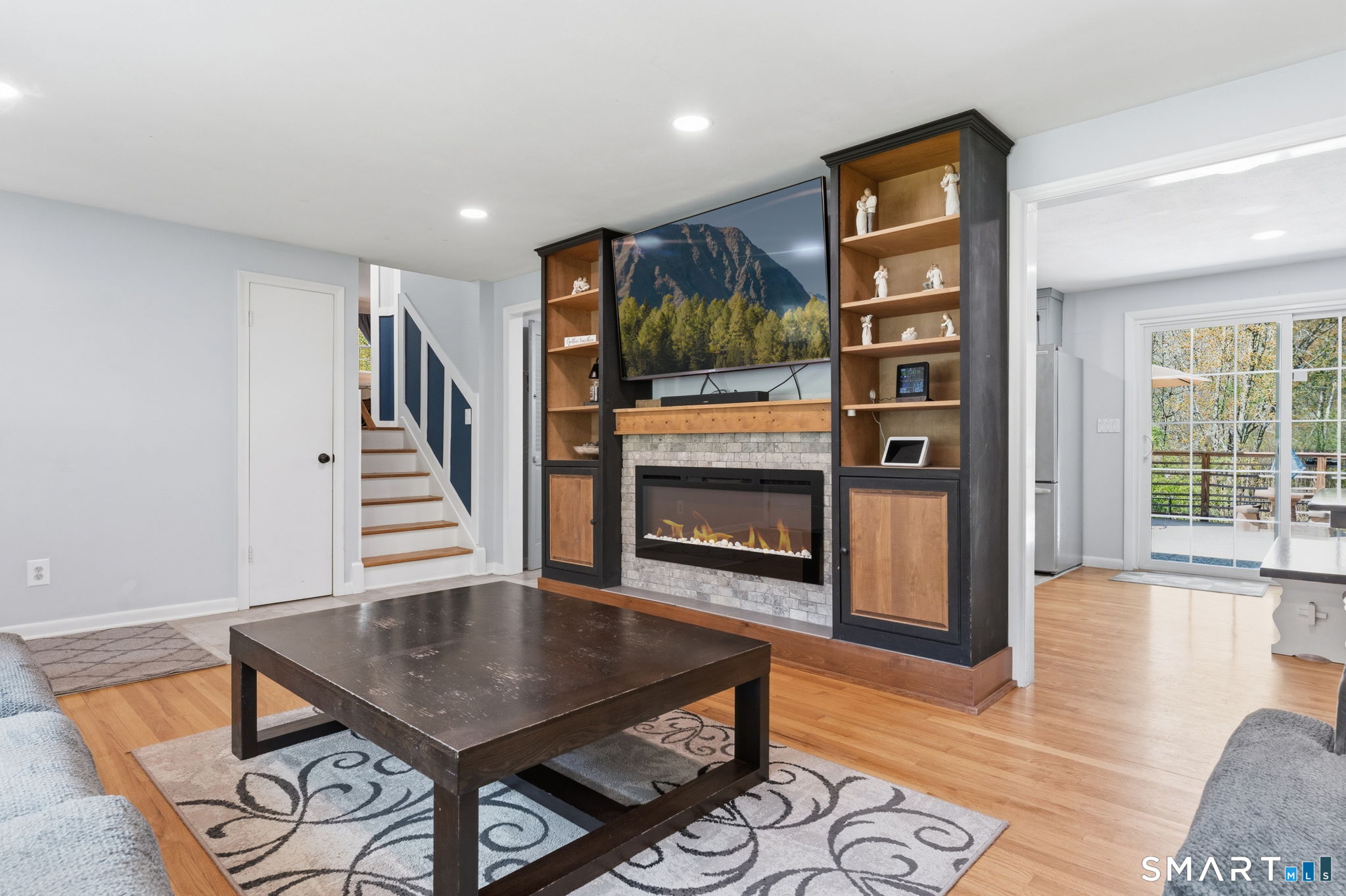 523 Essex Road Westbrook, CT 06498 - Photo 5 of 37 a living room with furniture a flat screen tv and a fireplace