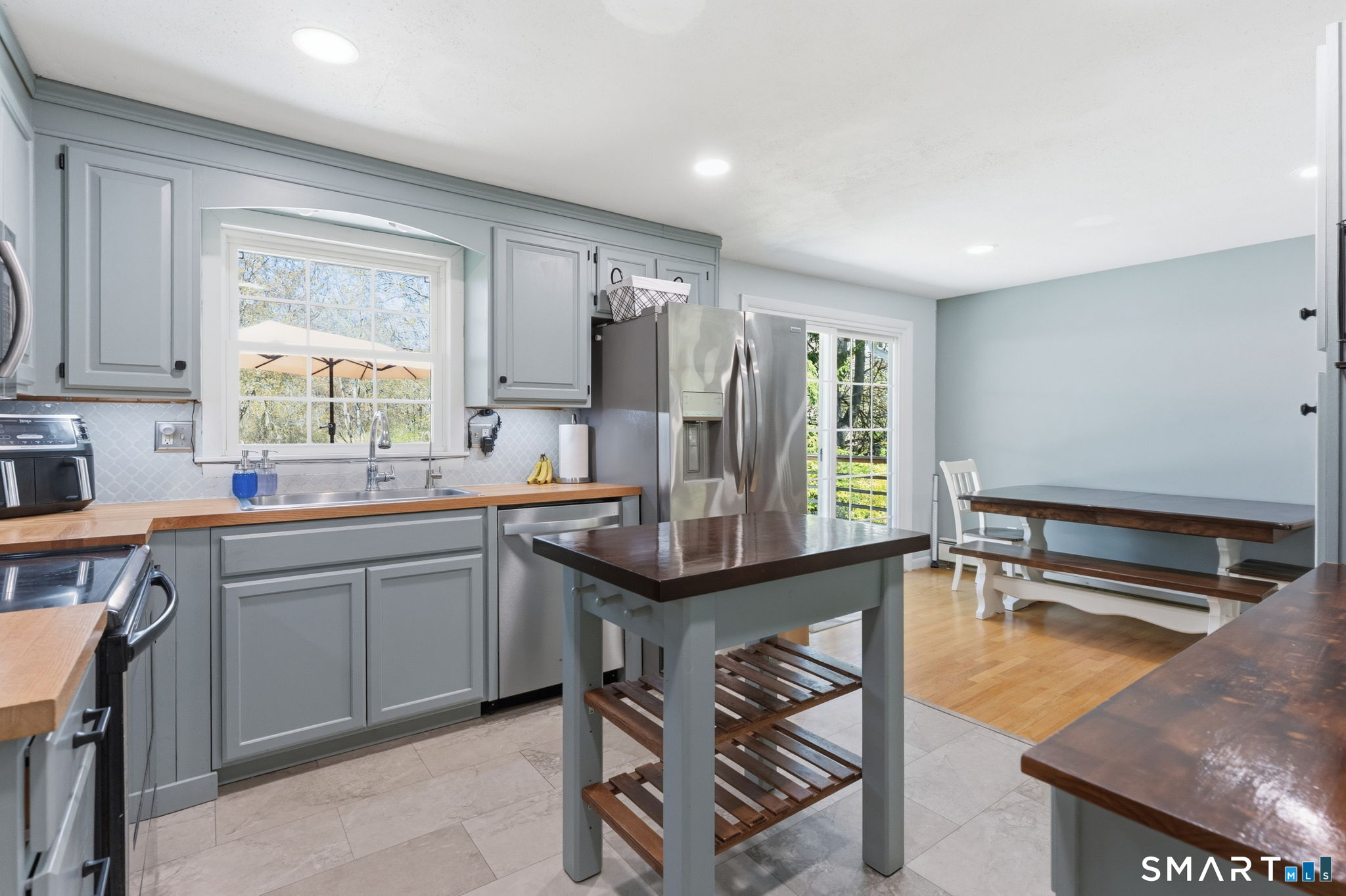 523 Essex Road Westbrook, CT 06498 - Photo 8 of 37 a kitchen with stainless steel appliances granite countertop a sink a stove and a refrigerator