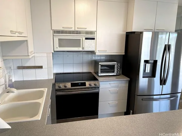 a kitchen with a refrigerator stove and microwave