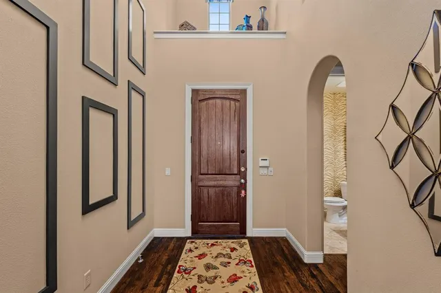 a view of a closet with wooden floor