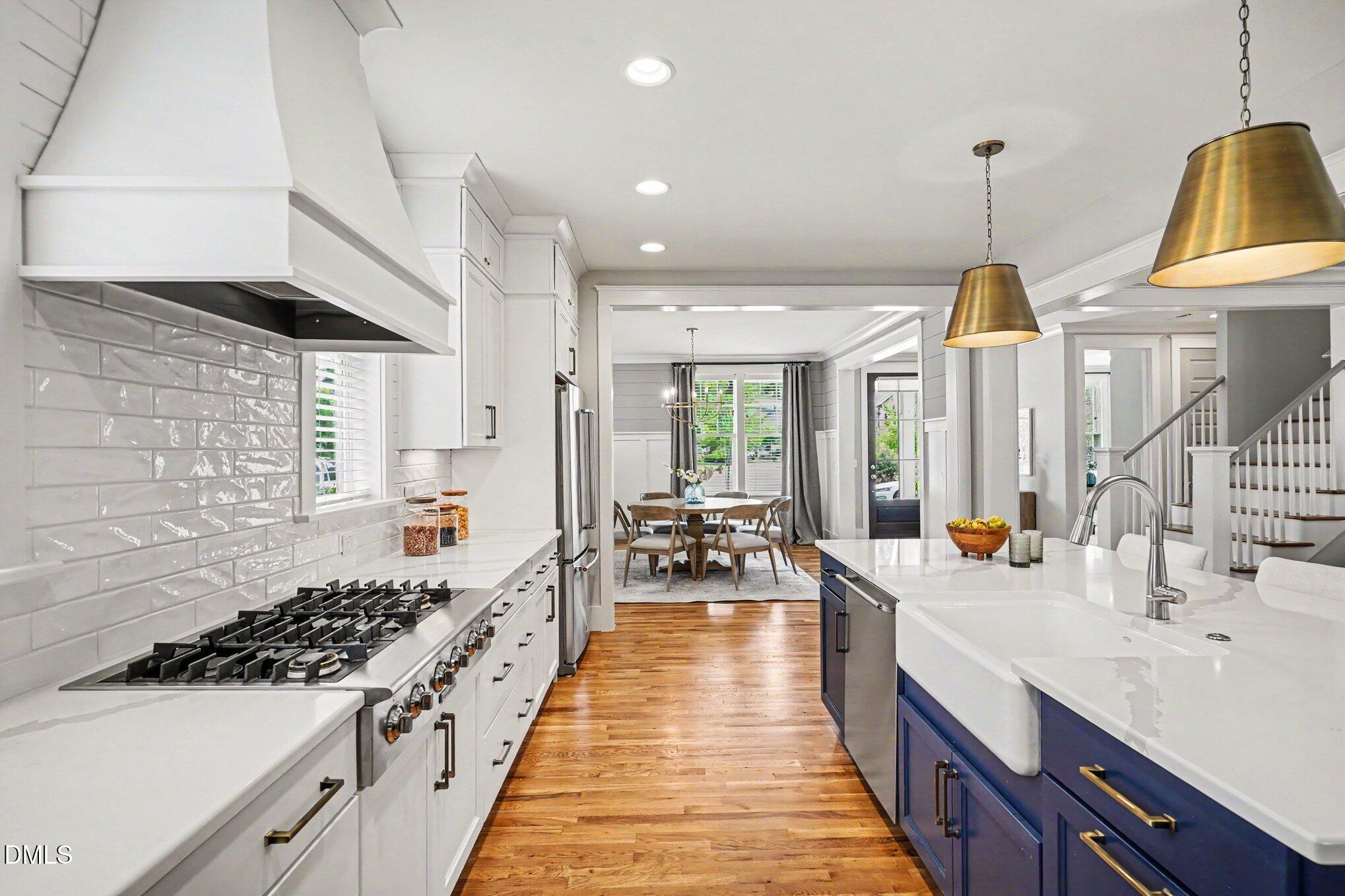 824 Watercolor Way Durham, NC 27713 - Photo 9 of 28 a kitchen with sink a stove and chairs