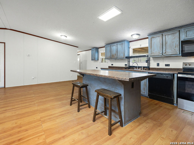 135 Savannah Ridge Von Ormy, TX 78073 - Photo 32 of 45 a kitchen with stainless steel appliances granite countertop a sink a stove a refrigerator and cabinets
