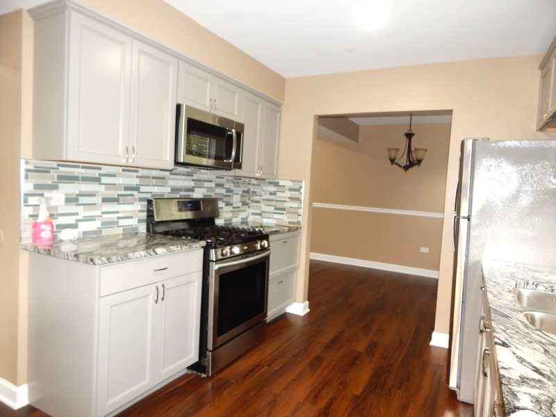 1216 Calico Avenue Naperville, IL 60564 - Photo 7 of 16 a kitchen with stainless steel appliances granite countertop a stove and a refrigerator