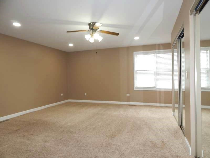 1216 Calico Avenue Naperville, IL 60564 - Photo 8 of 16 an empty room with windows and fan