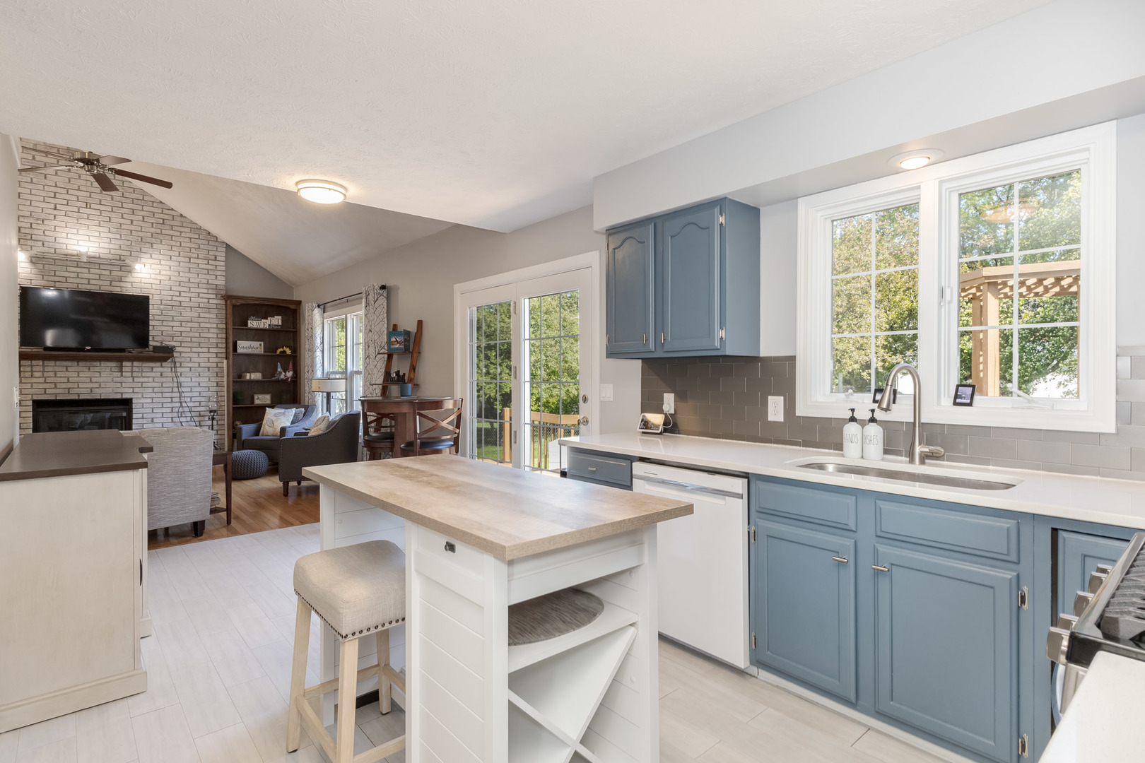 3308 Cumbria Drive Bloomington, IL 61704 - Photo 12 of 48 a kitchen with a stove a sink a dining table and chairs