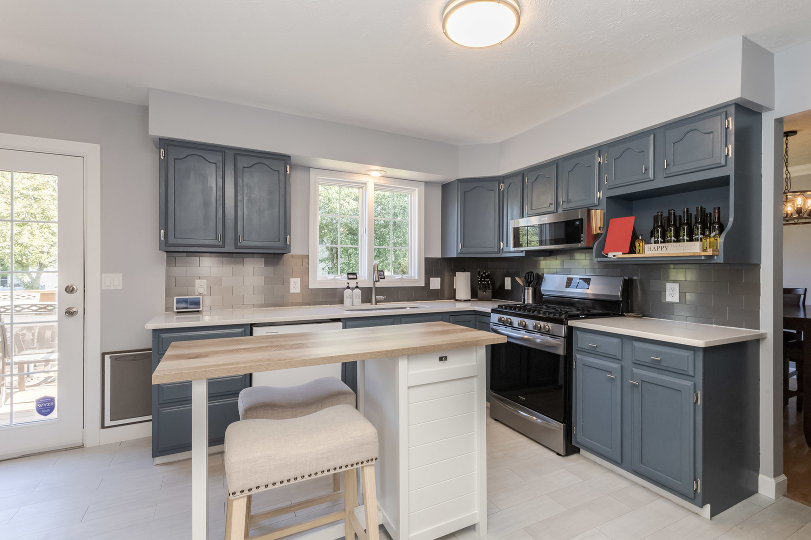 3308 Cumbria Drive Bloomington, IL 61704 - Photo 13 of 48 a kitchen with cabinets a window and stainless steel appliances