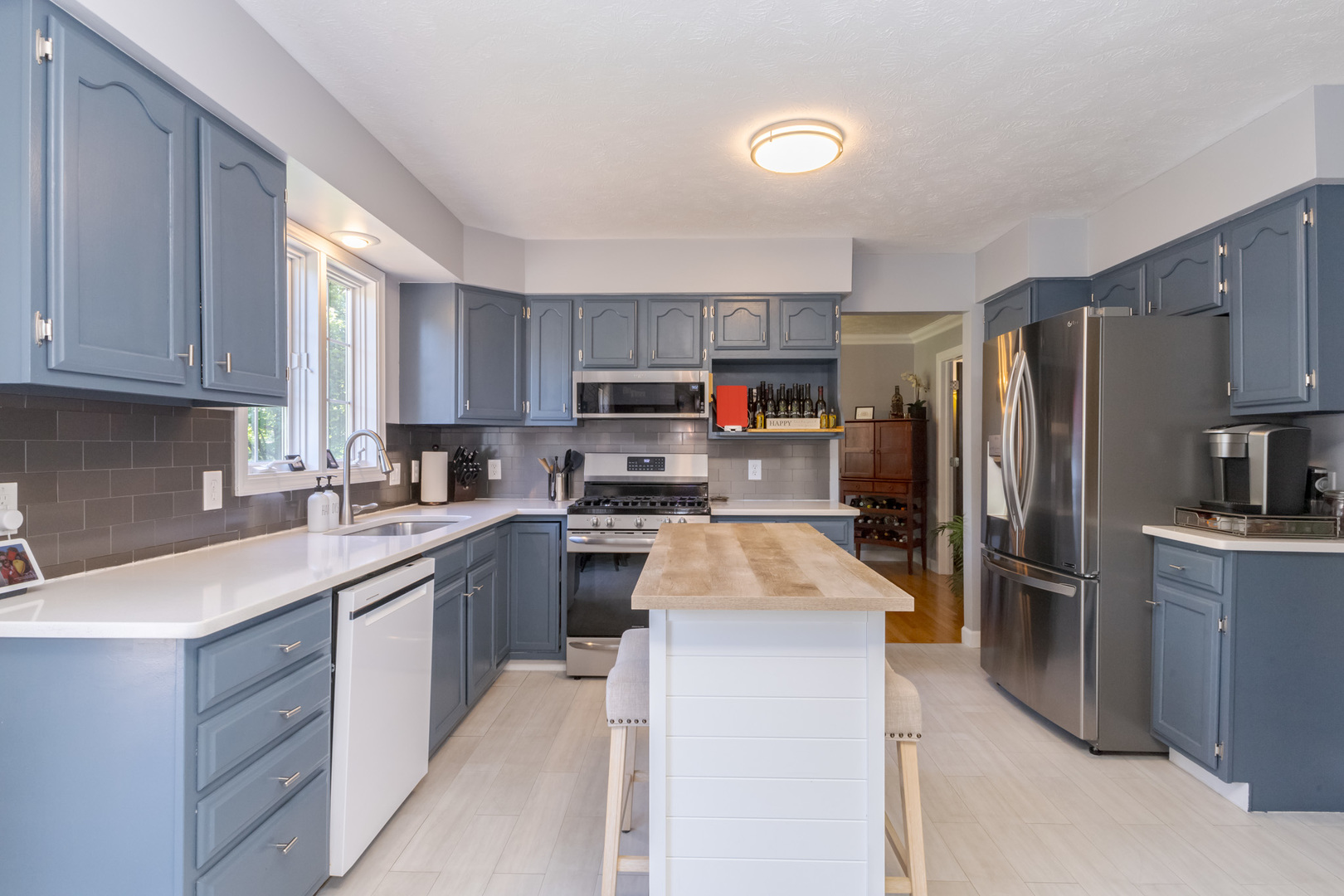 3308 Cumbria Drive Bloomington, IL 61704 - Photo 14 of 48 a kitchen with kitchen island a refrigerator sink and wooden cabinets