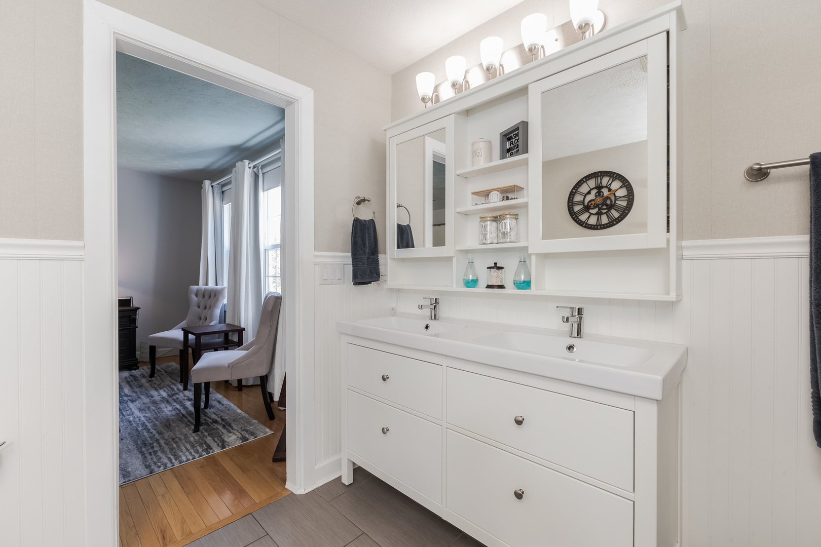 3308 Cumbria Drive Bloomington, IL 61704 - Photo 37 of 48 a view with a sink a mirror and a clock on the wall