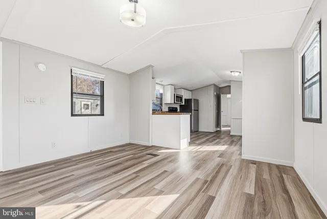 a view of wooden floor and windows in a room