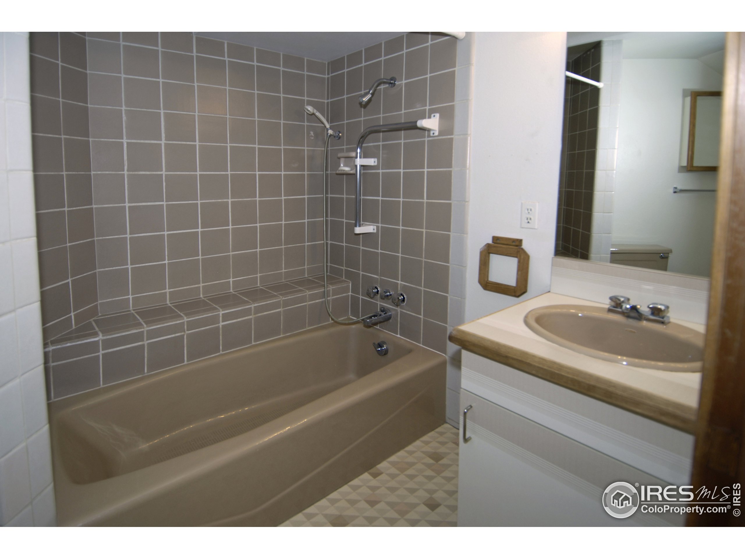 3945 Promontory Court Boulder, CO 80304 - Photo 11 of 18 a bathroom with a granite countertop sink a toilet and bathtub