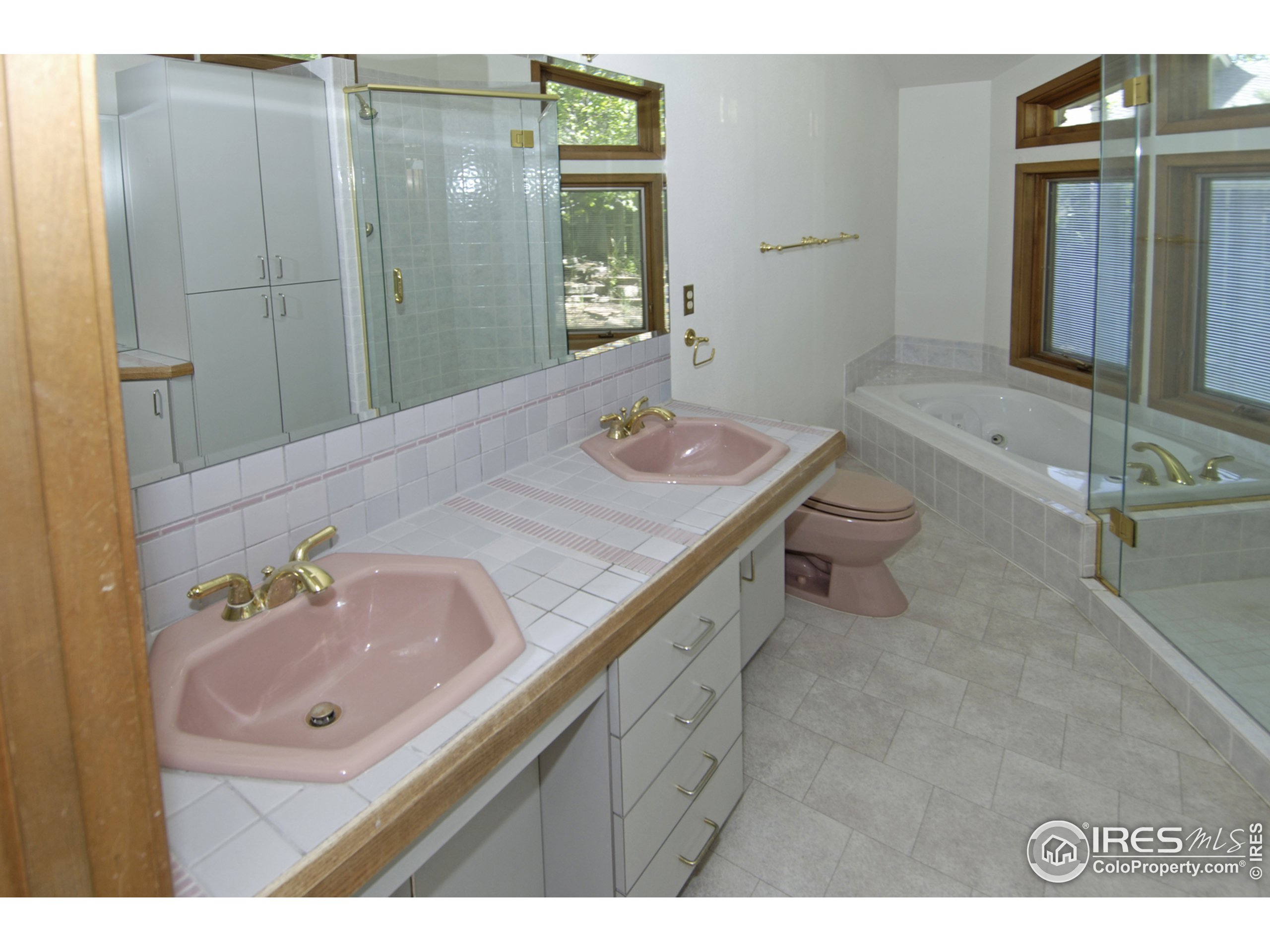 3945 Promontory Court Boulder, CO 80304 - Photo 13 of 18 a bathroom with a sink double vanity granite tub shower and a mirror