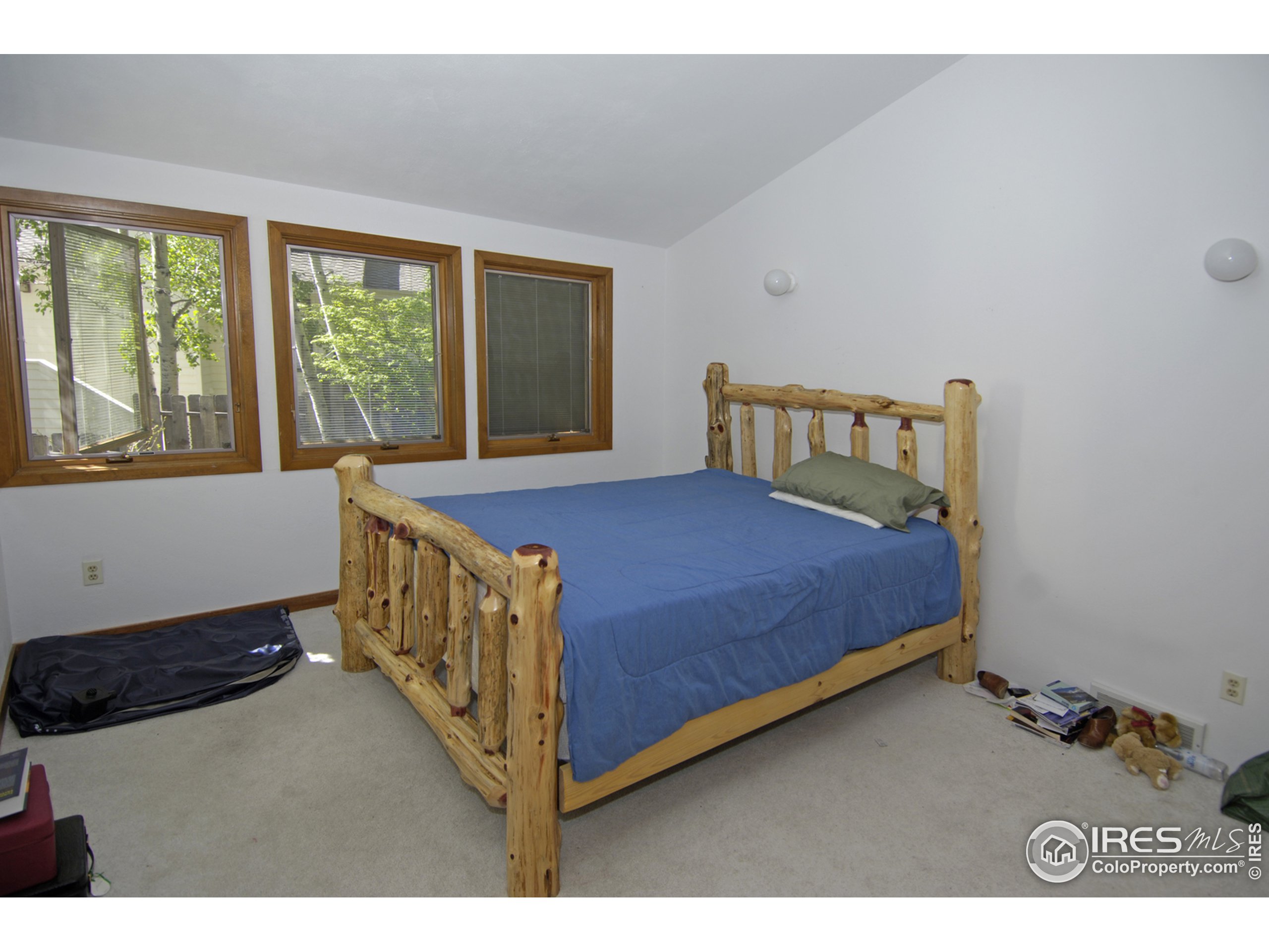 3945 Promontory Court Boulder, CO 80304 - Photo 14 of 18 a bedroom with a bed and a window