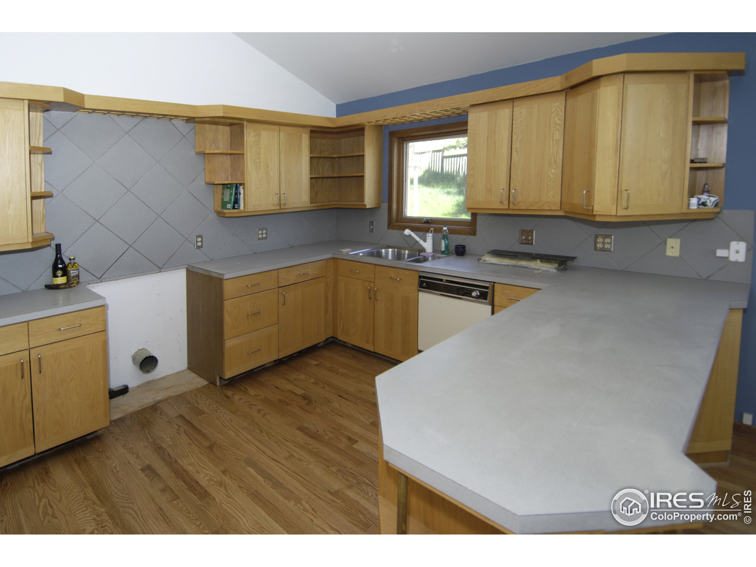 3945 Promontory Court Boulder, CO 80304 - Photo 7 of 18 a kitchen with a sink and wooden cabinets