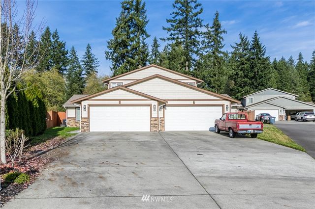 a view of front of a house with a yard and garage