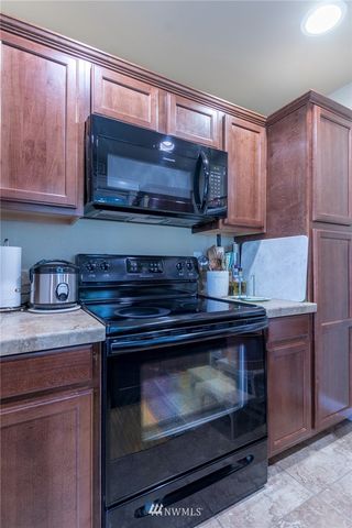 a stove top oven sitting inside of a kitchen