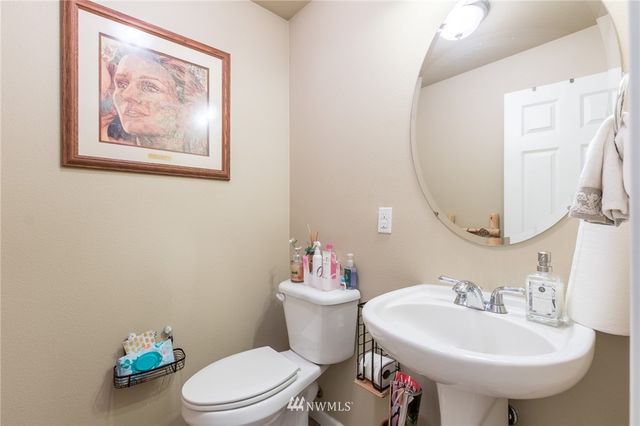 a bathroom with a sink mirror and toilet