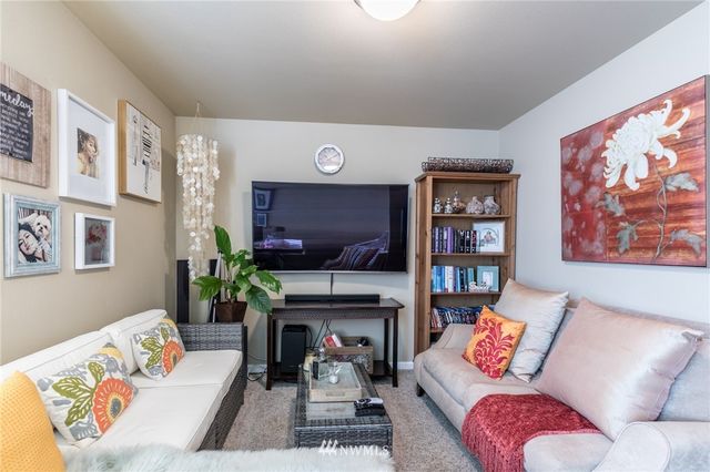 a living room with furniture fireplace and a large window