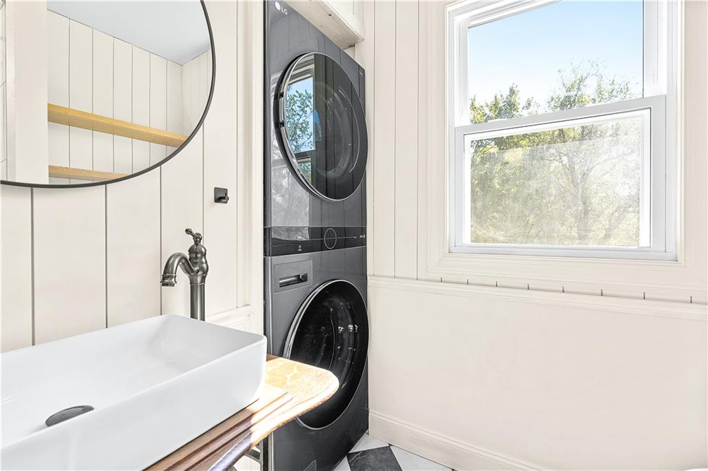 115 Elm Lane Coraopolis, PA 15108 - Photo 22 of 50 a bathroom with a sink a mirror a bathtub and next to a window