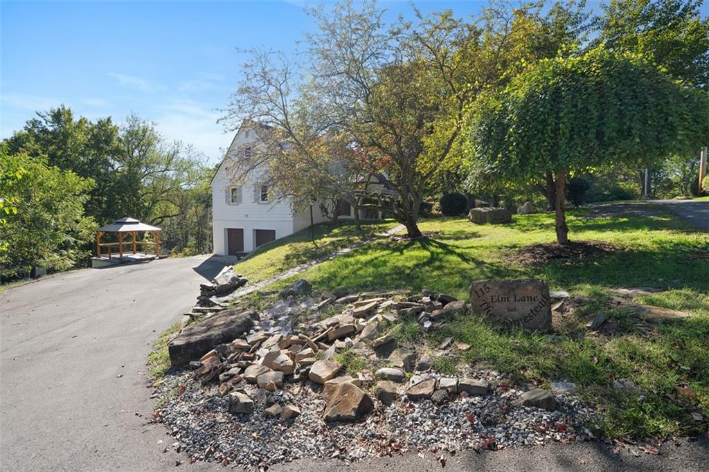 115 Elm Lane Coraopolis, PA 15108 - Photo 5 of 50 a view of a yard with plants and a large tree