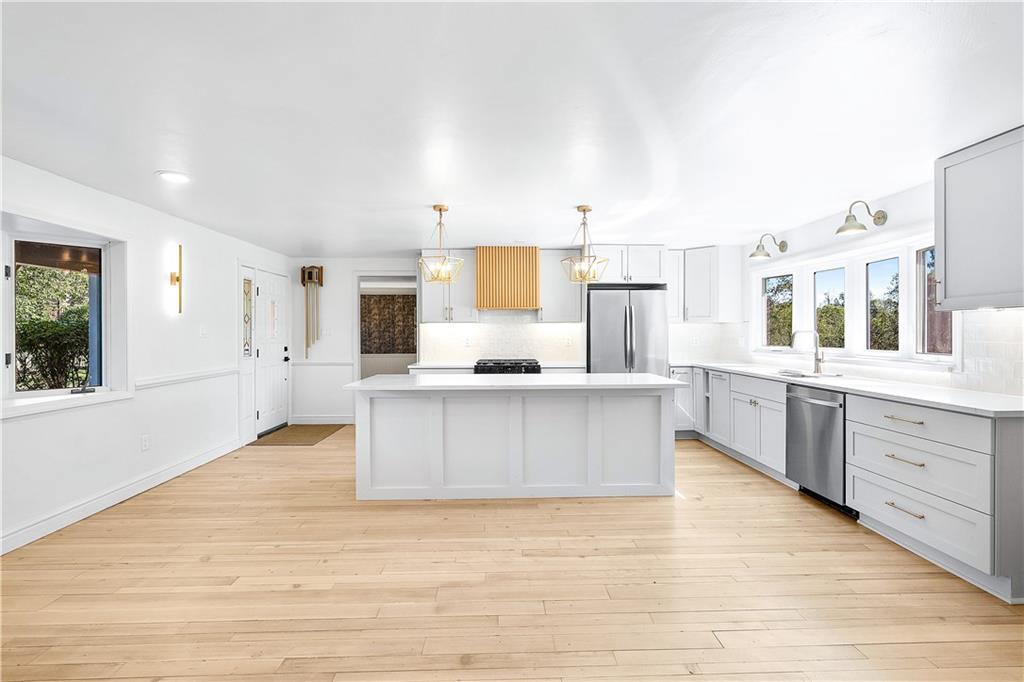 115 Elm Lane Coraopolis, PA 15108 - Photo 8 of 50 a large white kitchen with kitchen island white cabinets and stainless steel appliances