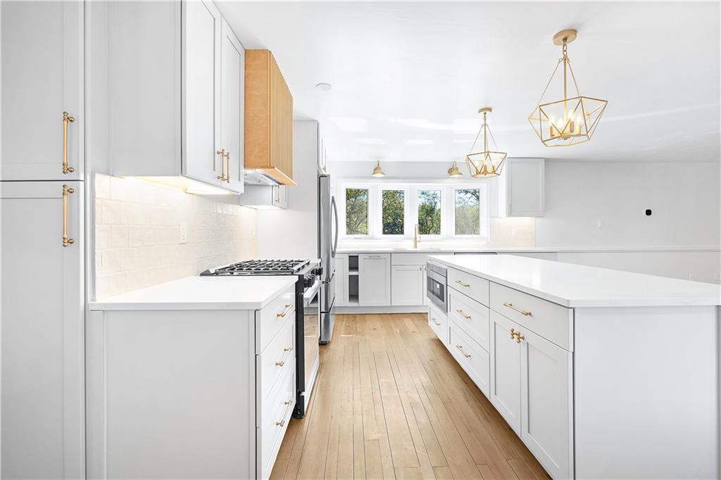 115 Elm Lane Coraopolis, PA 15108 - Photo 9 of 50 a kitchen with cabinets a center island and stainless steel appliances