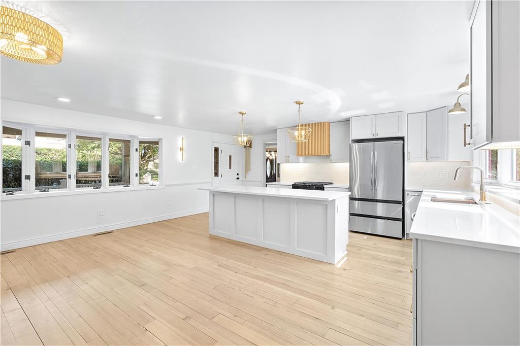 115 Elm Lane Coraopolis, PA 15108 - Photo 10 of 50 a large kitchen with stainless steel appliances kitchen island granite countertop a refrigerator stove a sink and dishwasher with wooden floor