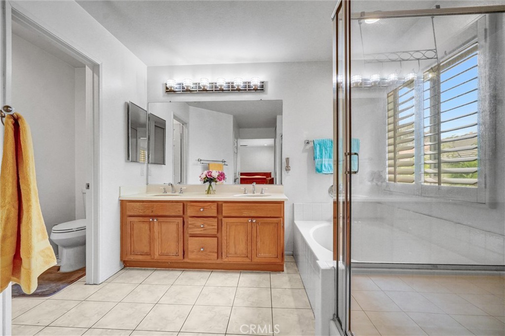 11 Brookhollow Irvine, CA 92602 - Photo 22 of 41 a spacious bathroom with a granite countertop sink a toilet a mirror and shower