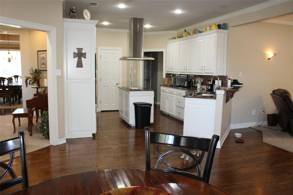 2131 Deer Run Denison, TX 75020 - Photo 24 of 35 a kitchen with stainless steel appliances granite countertop a refrigerator a stove and white cabinets with wooden floor