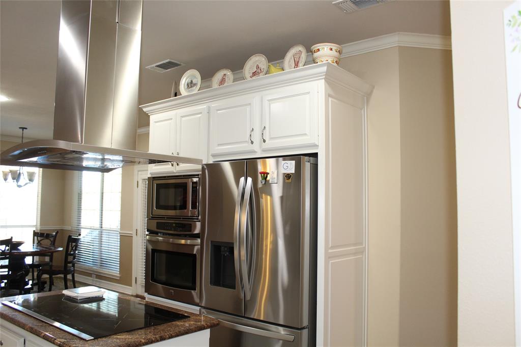 2131 Deer Run Denison, TX 75020 - Photo 26 of 35 a kitchen with stainless steel appliances a refrigerator and a stove