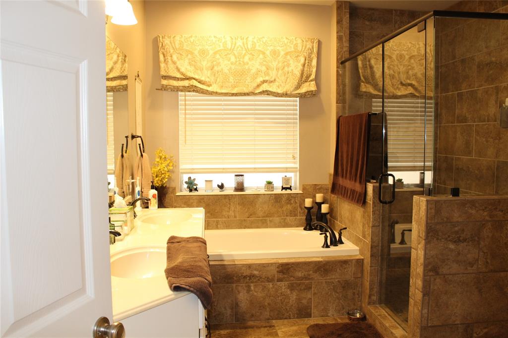2131 Deer Run Denison, TX 75020 - Photo 30 of 35 a bathroom with a tub and a large window
