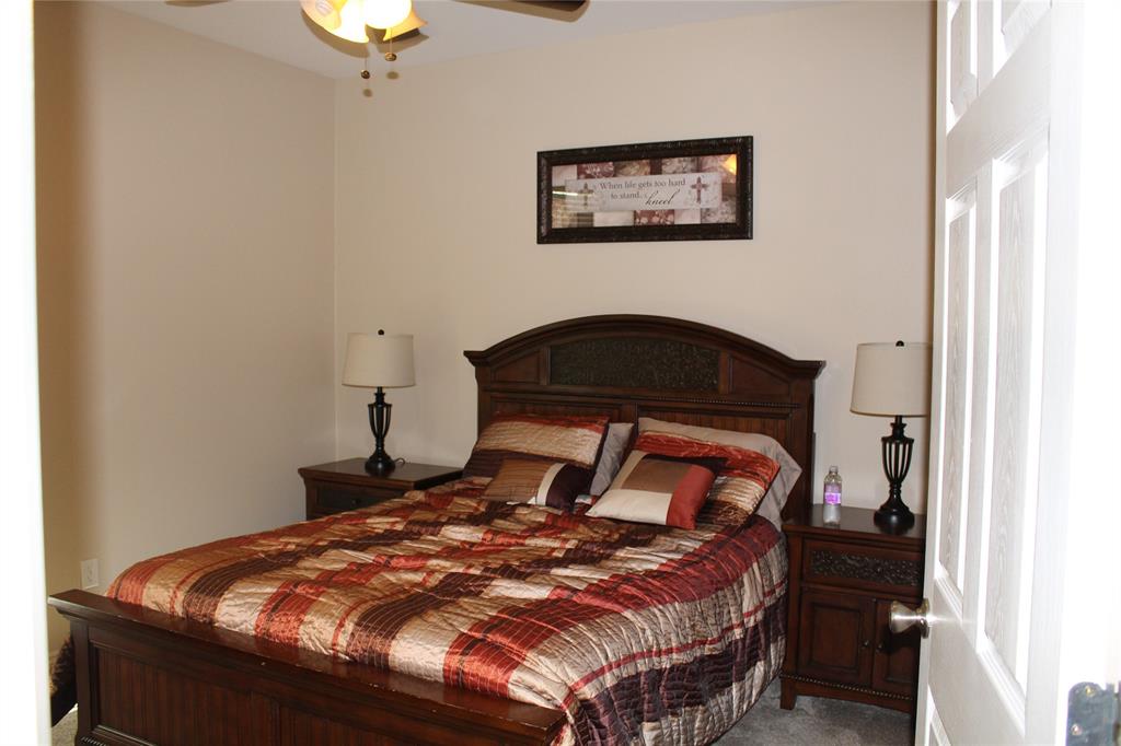 2131 Deer Run Denison, TX 75020 - Photo 31 of 35 a bedroom with a bed and a dresser