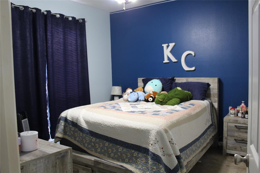 2131 Deer Run Denison, TX 75020 - Photo 32 of 35 a bedroom with a bed and a dresser