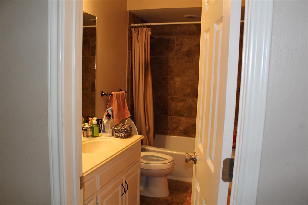 2131 Deer Run Denison, TX 75020 - Photo 35 of 35 a bathroom with a granite countertop sink toilet and shower