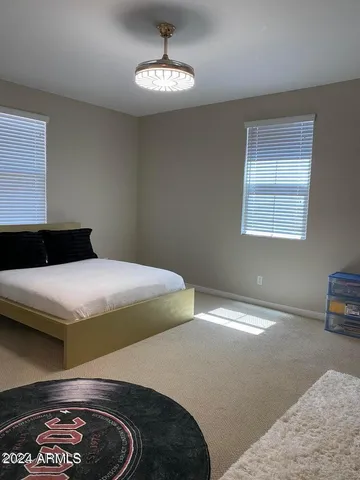 an empty room with closet and a ceiling fan
