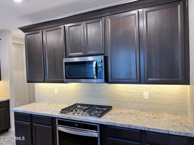 a kitchen with granite countertop cabinets and stainless steel appliances